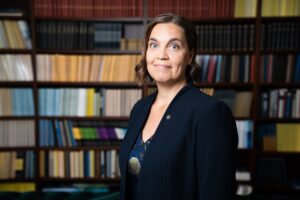 A photo of Heidi Kuusniemi smiling at the camera